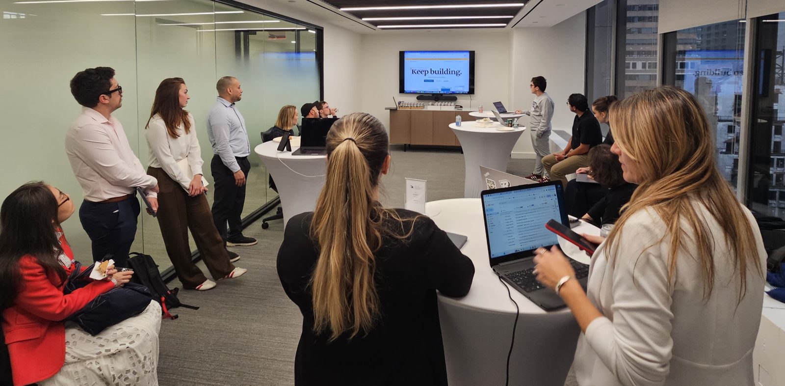 Legal engineers at the first Legal Engineers NYC session, laptops open, watching a live build on screen